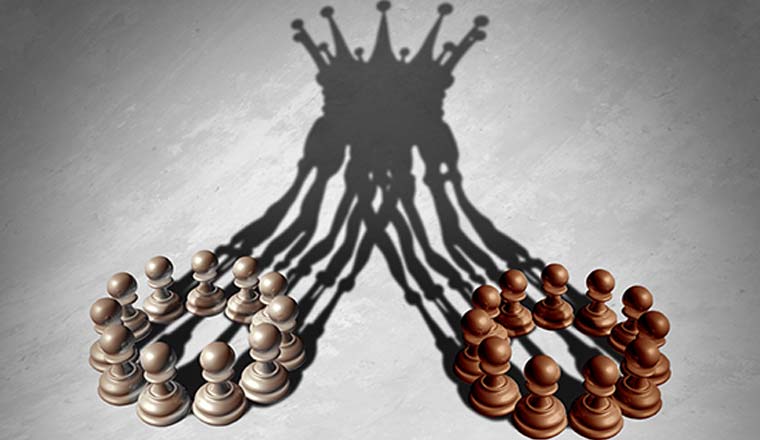 Two groups of pawns whose shadows are merging together into a crown