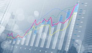 A bar chart and growing graphs with depth of field on bright tone background