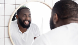 A picture of a smiling person looking into a mirror