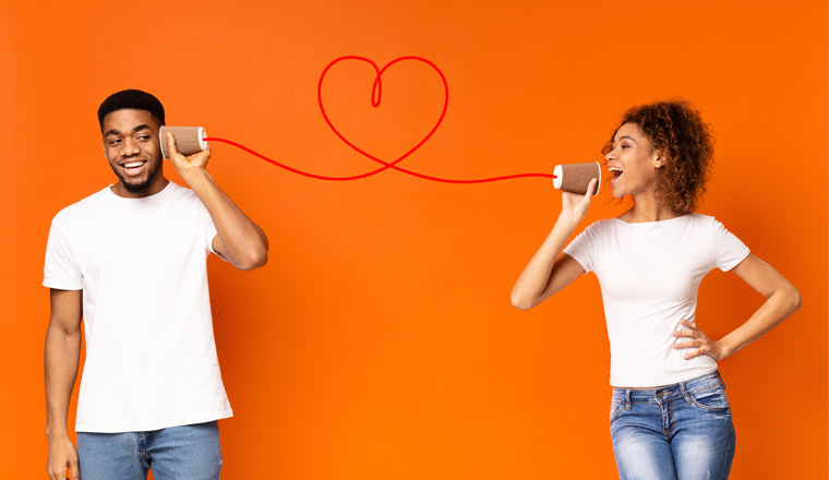Two people with a can phone on an orange background