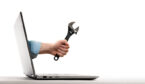 The human hand with black wrench stick out of a laptop screen