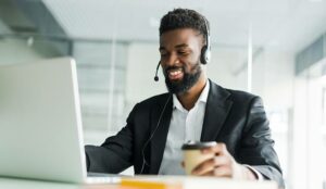 A customer support operator with hands-free headset working in the office.