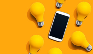 Smartphone with yellow light bulbs from above