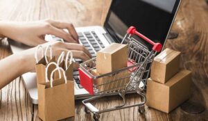 Cartons in a shopping cart on a laptop keyboard