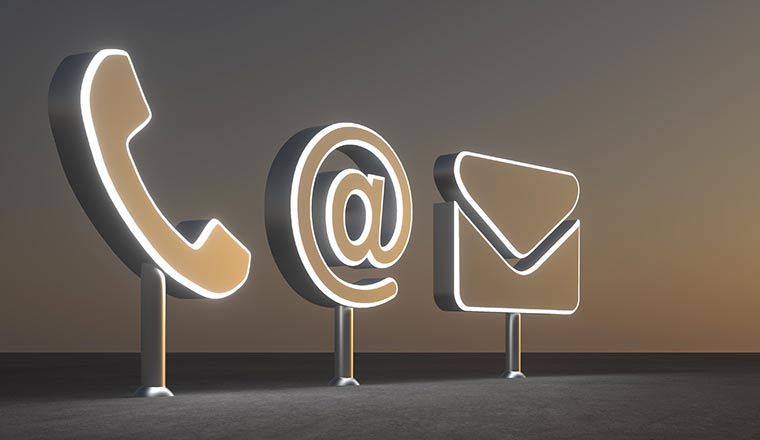 Phone, email and online contact icons in 3D in front of sunset