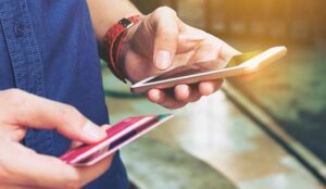 Person entering card details into a phone