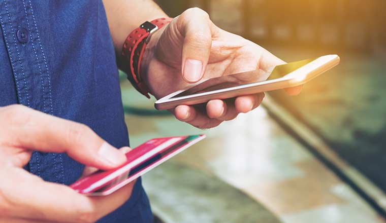 Person entering card details into a phone