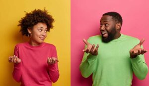 Two people on isolated backgrounds shrugging