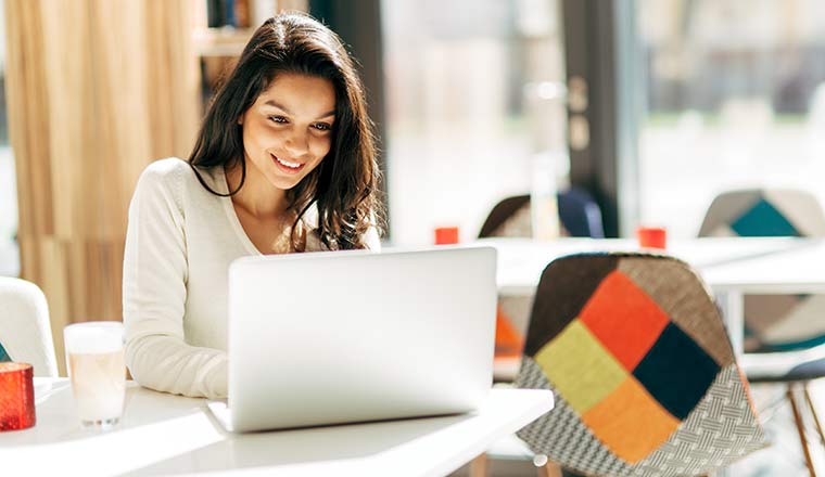 Person working from a cafe on a laptop