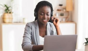 Person wearing headset sat at laptop