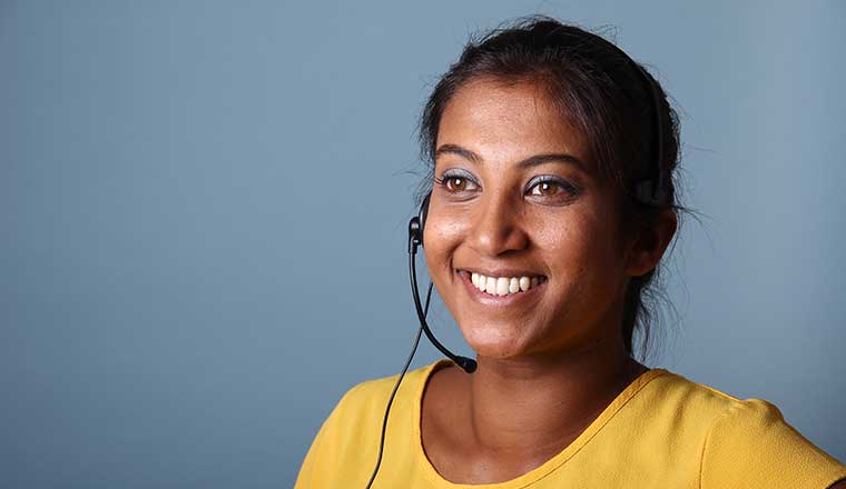 Person smiling and wearing a headset