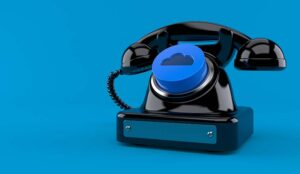 Old telephone with cloud button on blue background