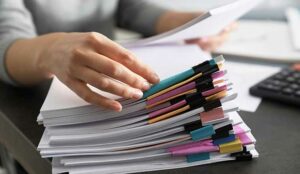 Office employee working with documents at table