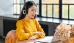 Person on headset in front of laptop