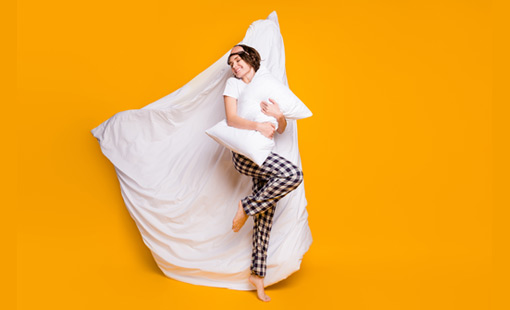 A picture of person lying on a duvet 