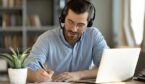 Person sitting at a desk with headset learning