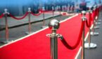 A red carpet and barrier on entrance