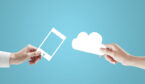 Two hands holding a phone and cloud cutout on a blue background