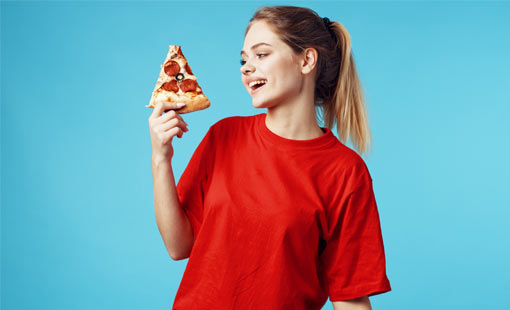 A picture of a girl holding a slice of Pizza