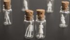 An image of small plastic people in jars