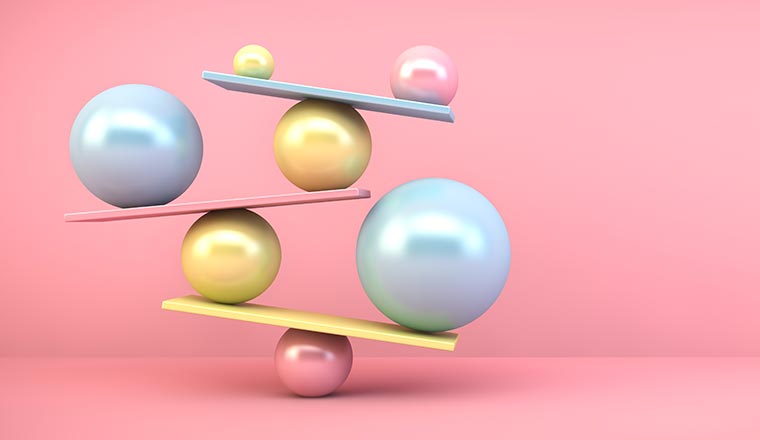 Close-up Of Balanced Spheres Against Pink Background