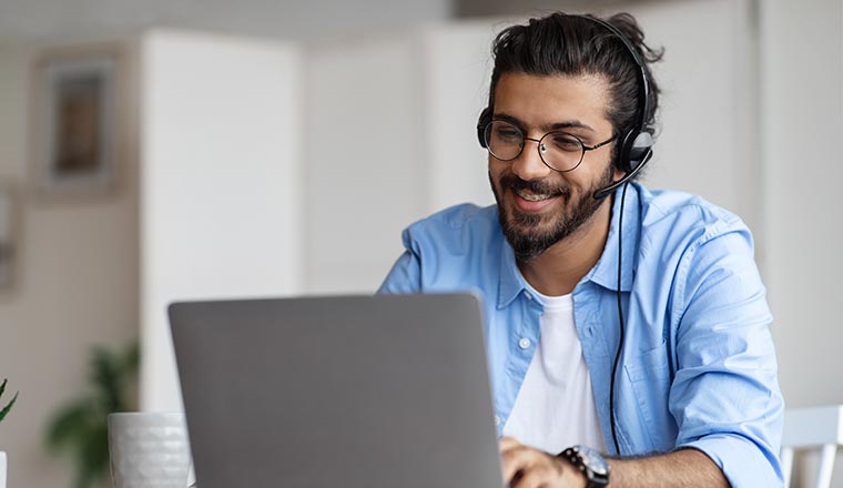 Person In Headset Working With Laptop
