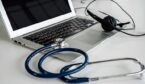 A stethoscope and headset on a laptop