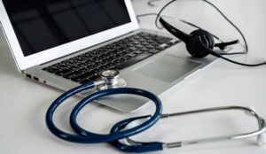 A stethoscope and headset on a laptop