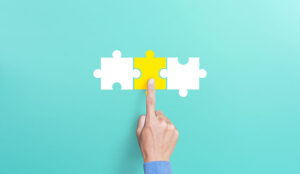 Mergers and acquisition concept with puzzle pieces on blue background