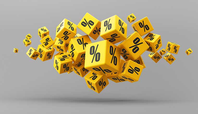 Flying yellow percentage cubes on a gray background.