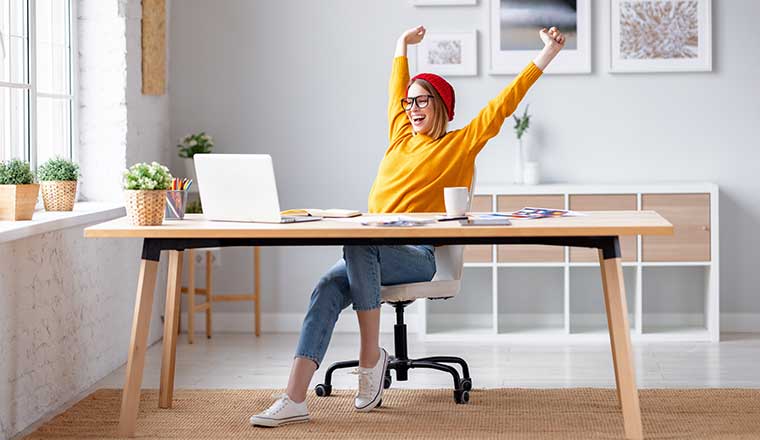 Person working from home celebrating