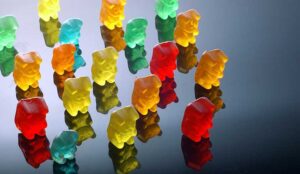 Gummy bears lined up and facing the same direction in a group
