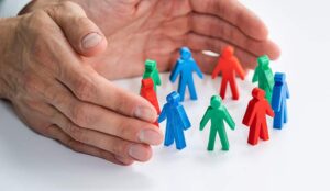 Hand Protecting Employee Figures Staff Retention Concept