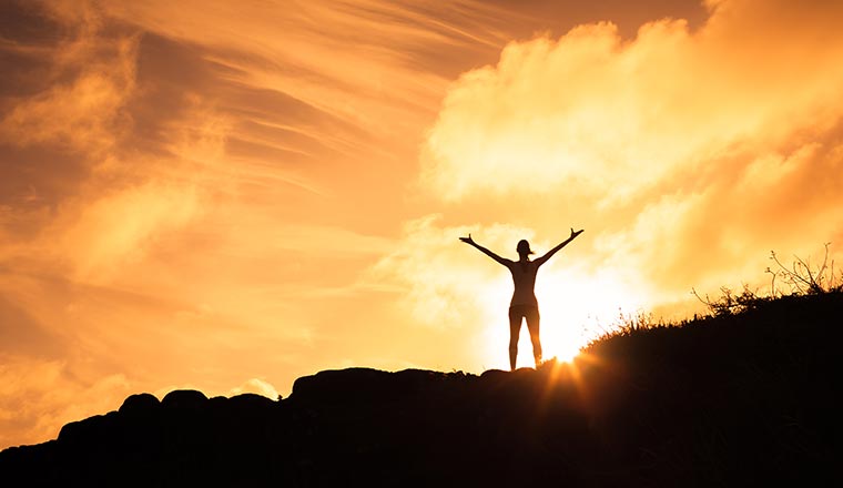 Empowered person standing on mountain