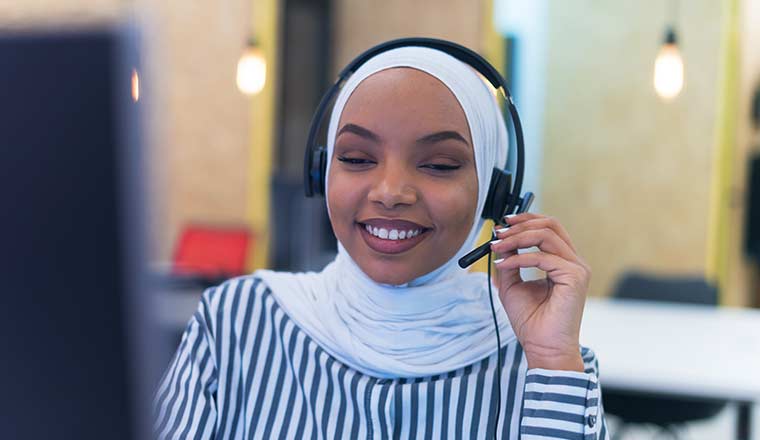 A customer representative with phone headset helping and supporting customer
