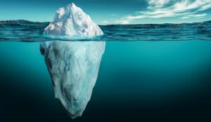 Iceberg with its visible and underwater or submerged parts floating in the ocean