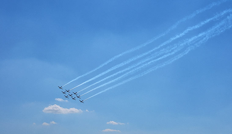 Low Angle View Of Airshow Against Blue Sky