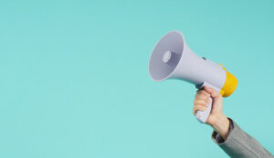 Hand holding a megaphone