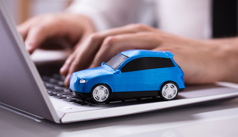 Blue Car On Laptop Keypad