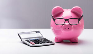 Piggybank With Eyeglasses And Calculator