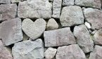 A stone wall with a heart representing empathy built in