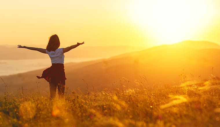 Person celebrating sunset