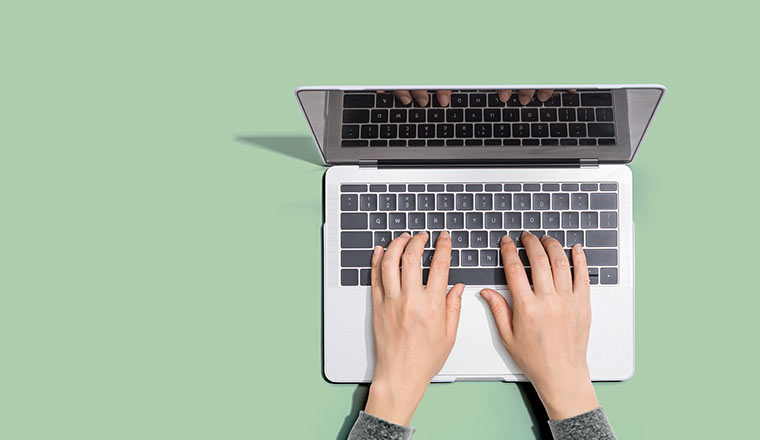 Person using a laptop computer from above