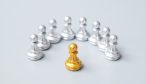A golden chess pawn pieces or leader stand out of crowd people of silver