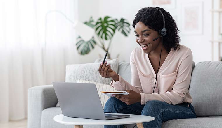 Person in headset on laptop