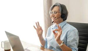 Older call centre operator at desk