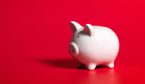 A piggy bank isolated on red background.