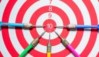 Score concept with dartboard and arrows pointing at 10
