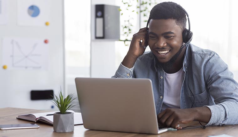 Person watching a webinar on laptop in office