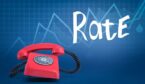 ringing red rotary phone on blurred blue background with line graphs and title 'Rate'.